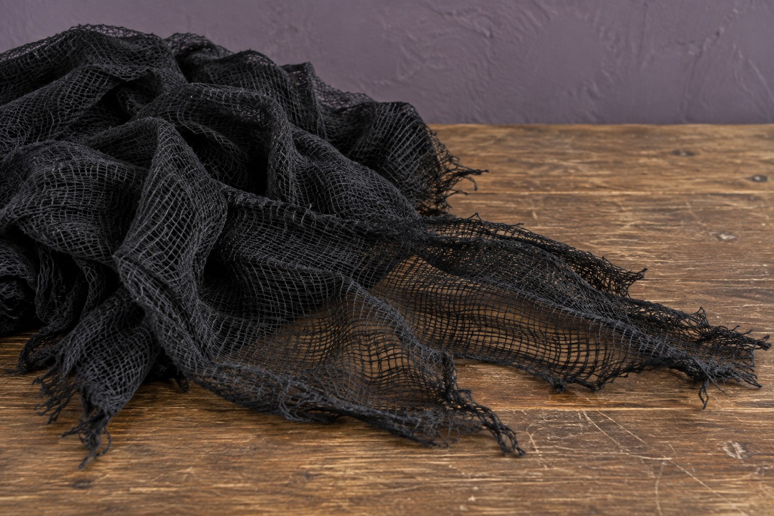 Styled illustration of black Halloween gauze, not the exact LessMo cloth